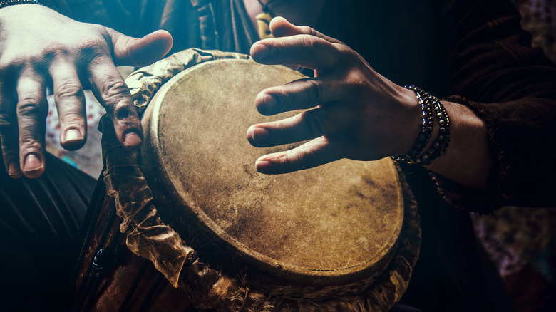 A,Man,Playing,An,Ethnic,Percussion,Musical,Instrument,Jembe.,Drummer